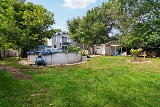 a view of a house with backyard sitting area and garden
