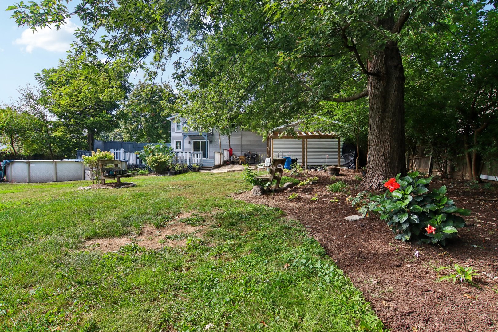 806 Spencer Street Joliet, IL 60433 - Photo 37 of 49 a view of a house with backyard sitting area and garden