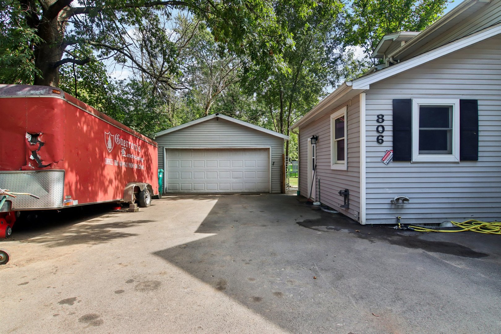 806 Spencer Street Joliet, IL 60433 - Photo 4 of 49 a view of a house with a yard and garage