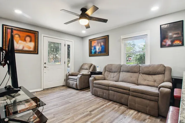 a living room with furniture a window and a flat screen tv