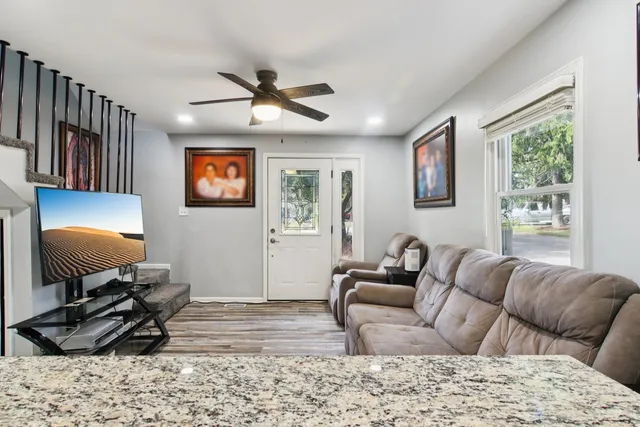 a living room with furniture and wooden floor