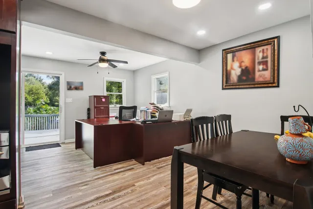 a kitchen with stainless steel appliances granite countertop a refrigerator a sink dishwasher a stove and oven with wooden floor