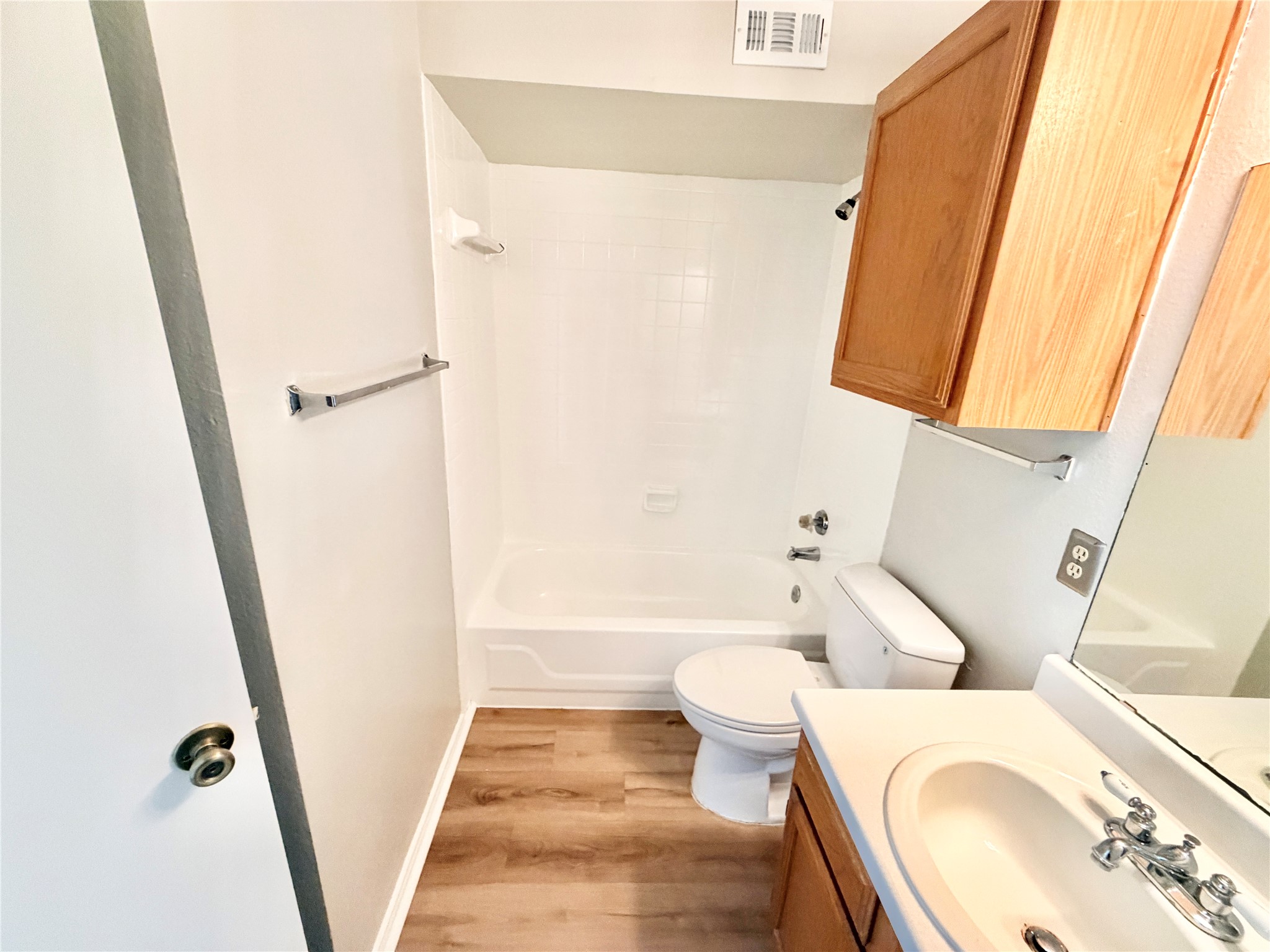 1730 Timber Ridge Road, Unit 152 Austin, TX 78741 - Photo 11 of 26 Bathroom with vanity, shower combination, and light wood finished floors