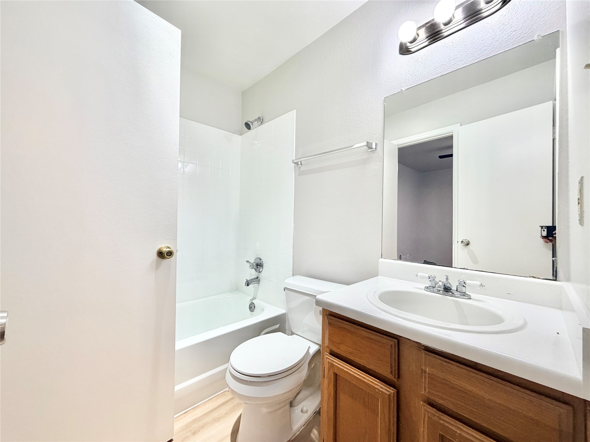 1730 Timber Ridge Road, Unit 152 Austin, TX 78741 - Photo 20 of 26 Bathroom with shower combination, vanity, and light wood-type flooring