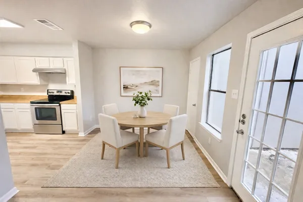 a dining room with furniture and window