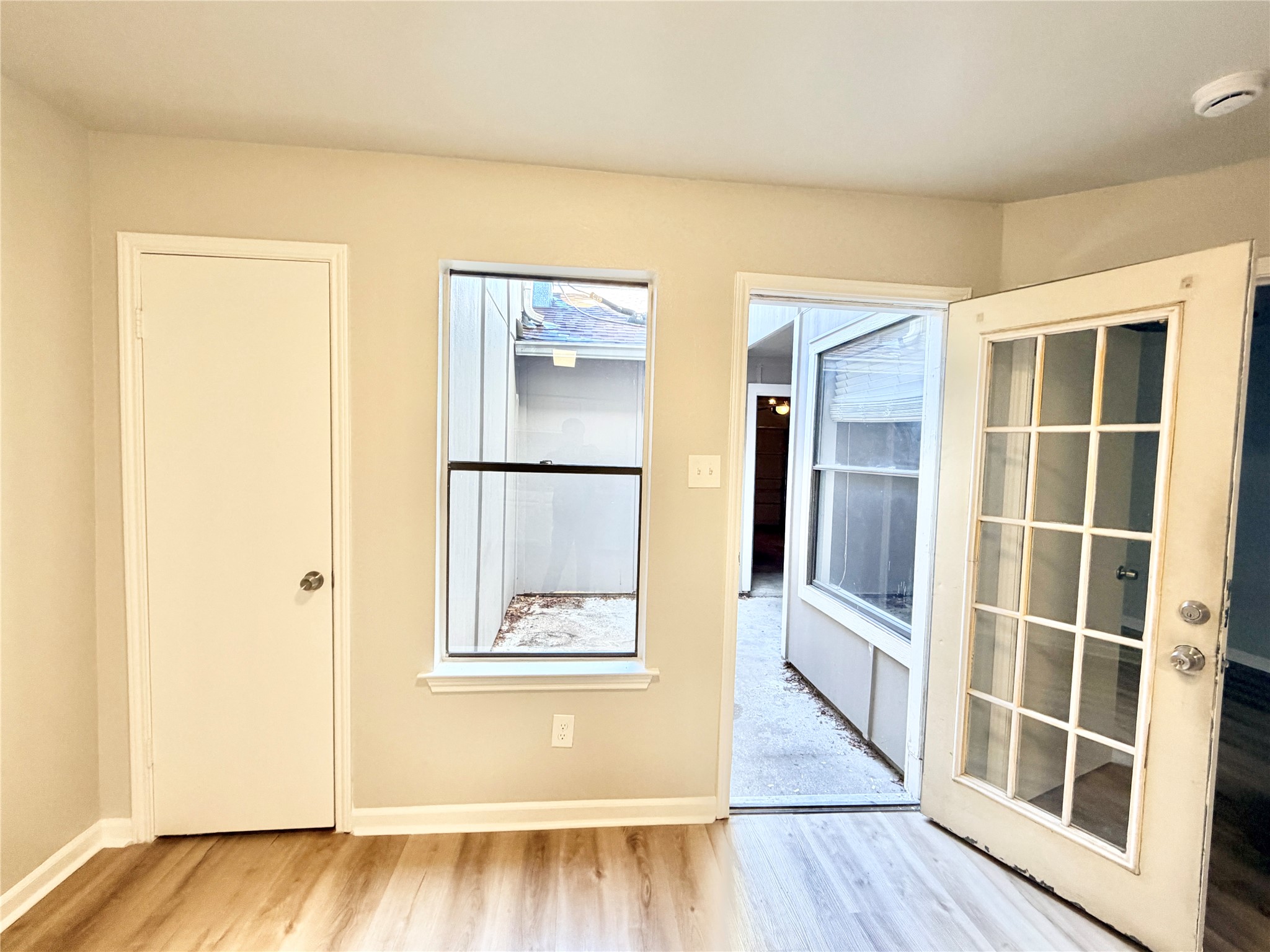 1730 Timber Ridge Road, Unit 152 Austin, TX 78741 - Photo 23 of 26 Empty room with light wood-style floors and baseboards
