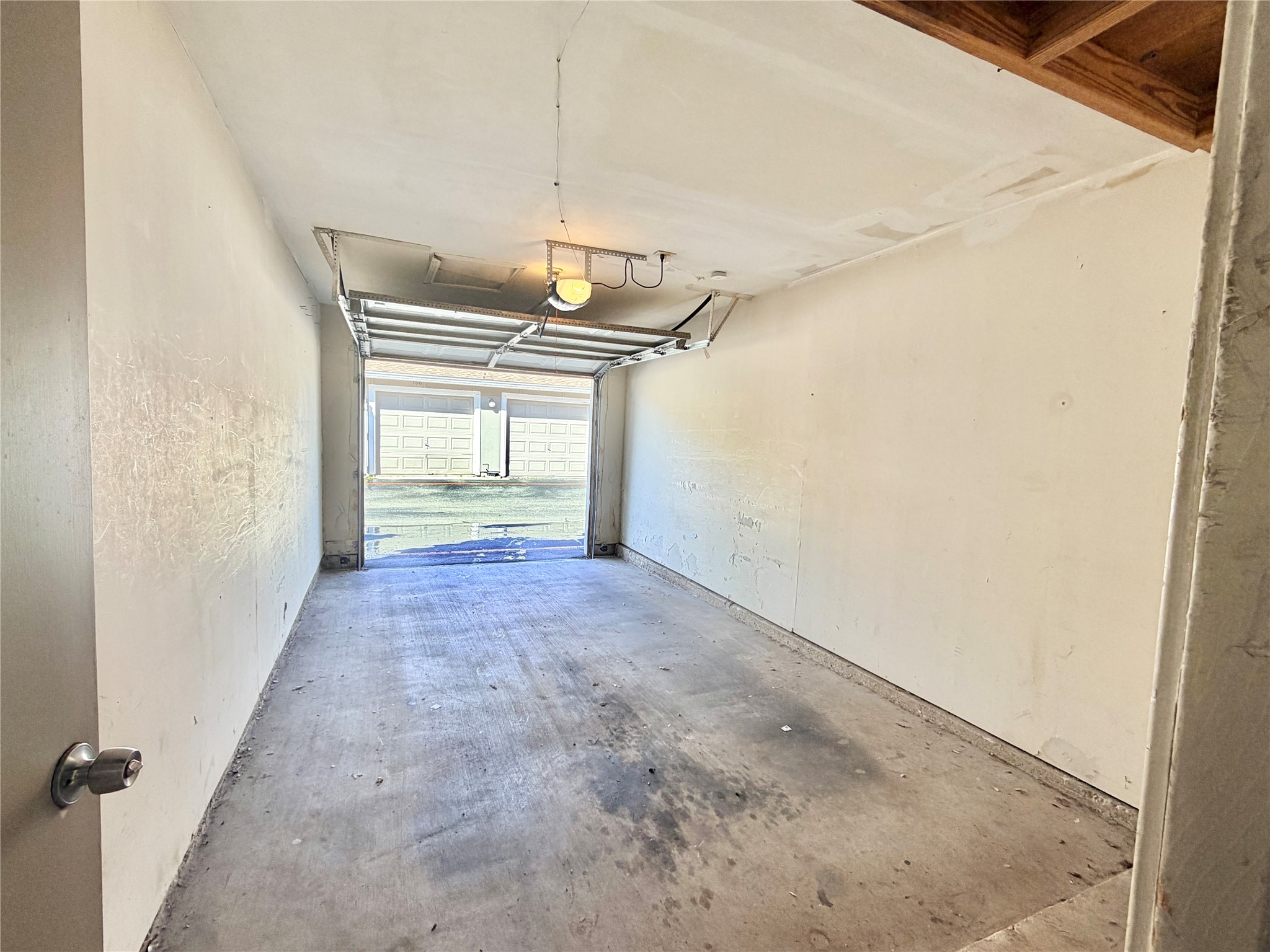 1730 Timber Ridge Road, Unit 152 Austin, TX 78741 - Photo 24 of 26 Garage featuring a textured wall