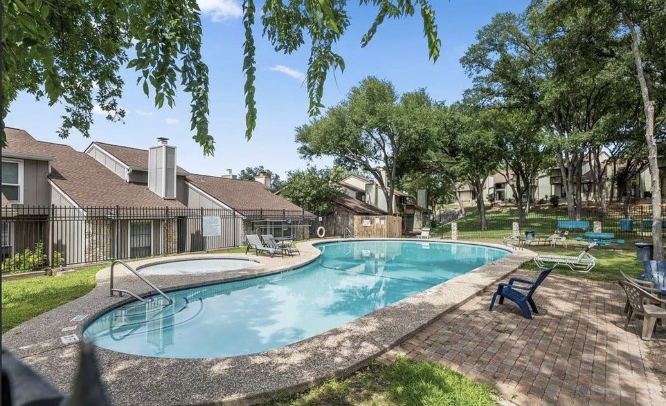 1730 Timber Ridge Road, Unit 152 Austin, TX 78741 - Photo 26 of 26 Community pool with a patio area and a residential view