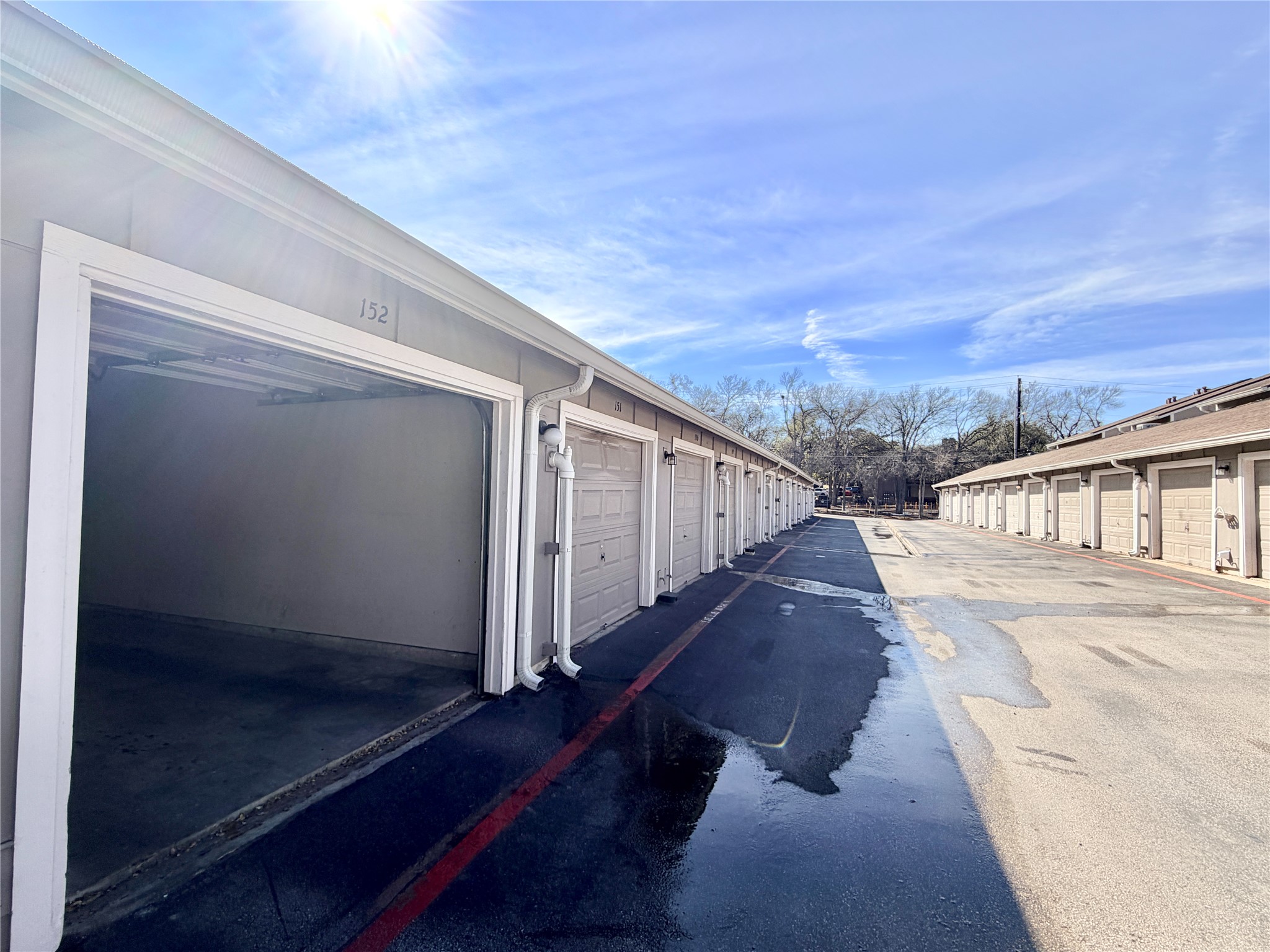 1730 Timber Ridge Road, Unit 152 Austin, TX 78741 - Photo 4 of 26 View of asphalt road featuring community garages