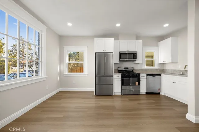 a kitchen with appliances a sink and lots of appliances