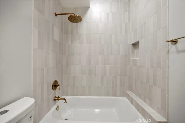 an empty room with a window and a ceiling fan