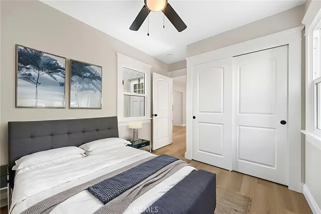 a bedroom with a large bed and a chandelier