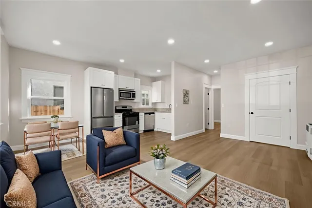 a living room with furniture and kitchen view