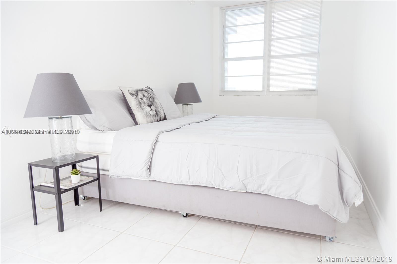 100 Lincoln Road, Unit 1216 Miami Beach, FL 33139 - Photo 2 of 7 a bedroom with a bed and a window