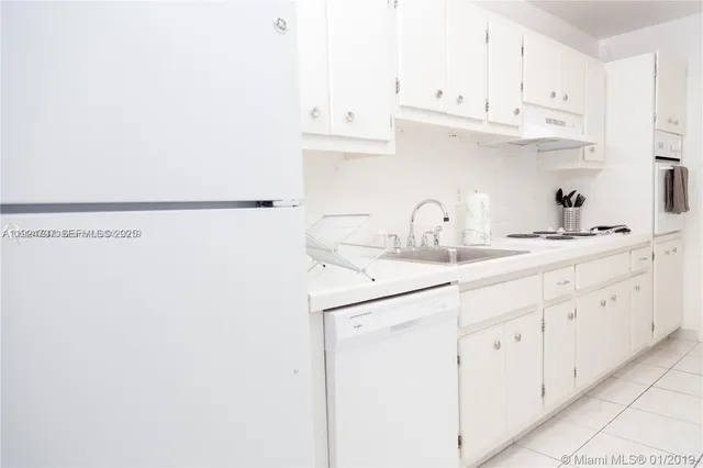 a kitchen with cabinets and white appliances