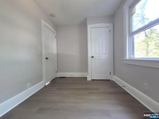 an empty room with a empty space and windows