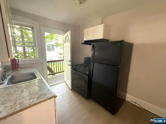 a kitchen with a refrigerator and a sink