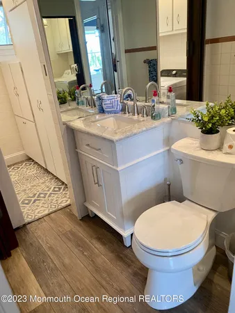 a bathroom with a toilet sink and mirror