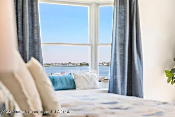 a spacious bedroom with a large bed and a large window