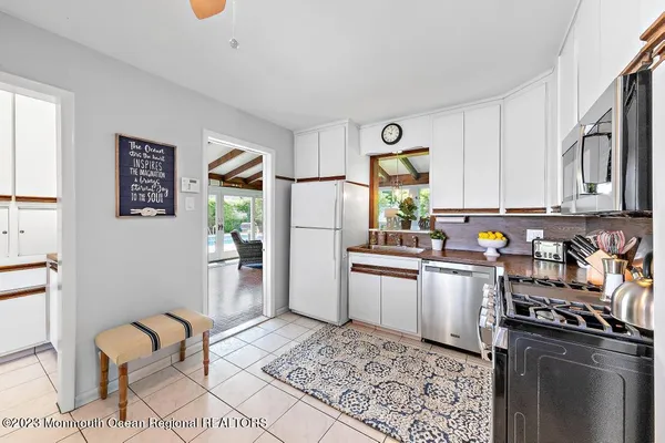 a kitchen with stainless steel appliances granite countertop a refrigerator sink and stove