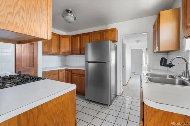 a kitchen with a refrigerator and a sink