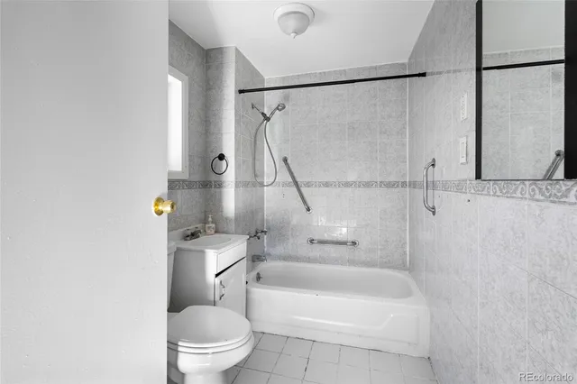 a white toilet sitting next to a bath tub