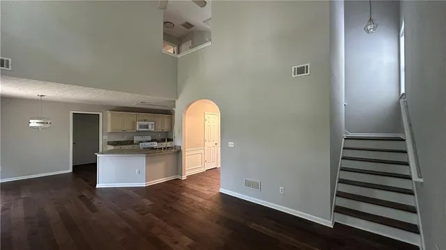 a view of a kitchen with wooden floor and electronic appliances