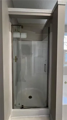 a bathroom with a glass shower door