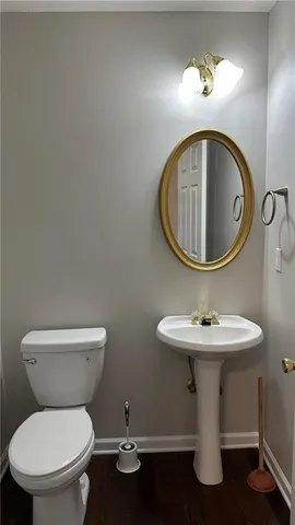 a bathroom with a toilet a sink and a mirror