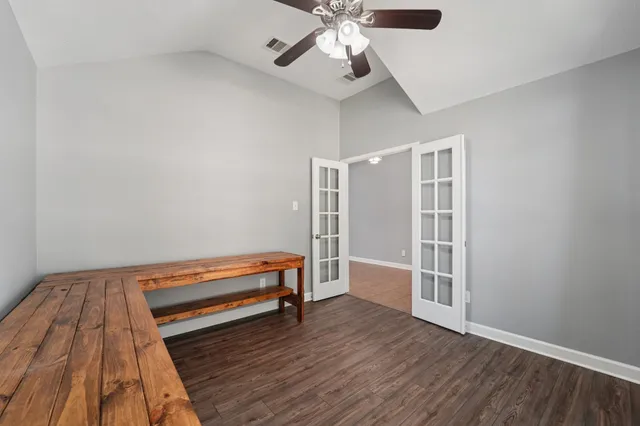 a view of room with wooden floor and ceiling fan