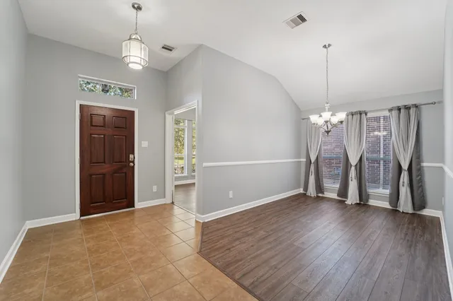 a view of a room with wooden floor staircase and kitchen space