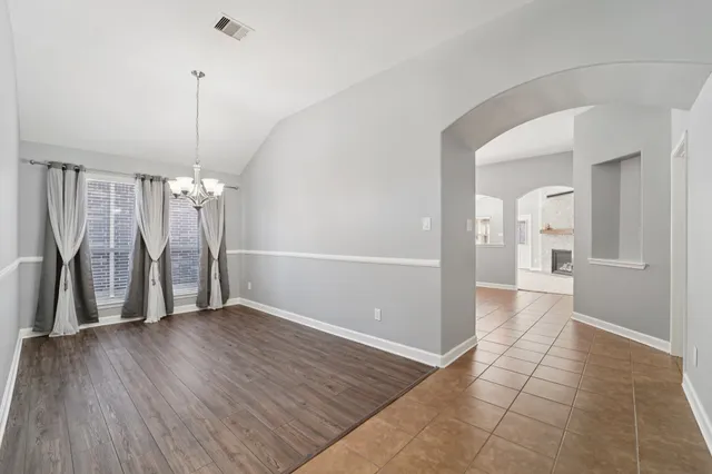 a view of a room with wooden floor