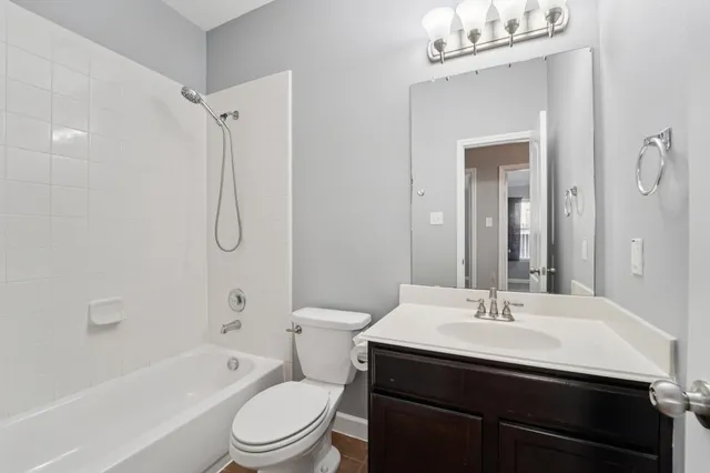 a bathroom with a sink toilet vanity and shower