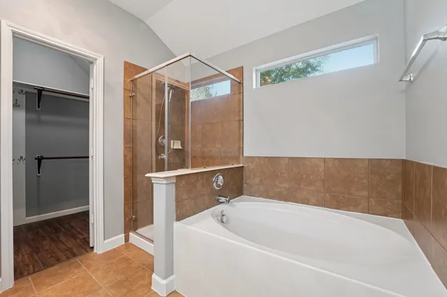 a bathroom with a tub and shower