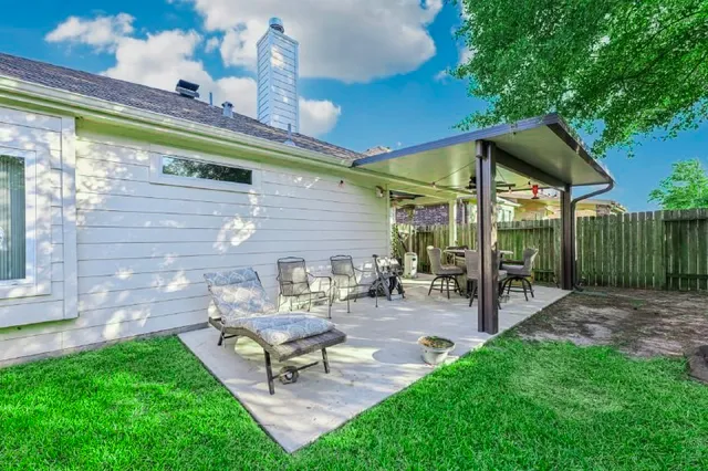 a view of a house with a yard and sitting area
