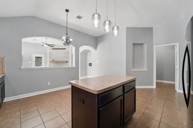 a kitchen with a counter space and a chandelier