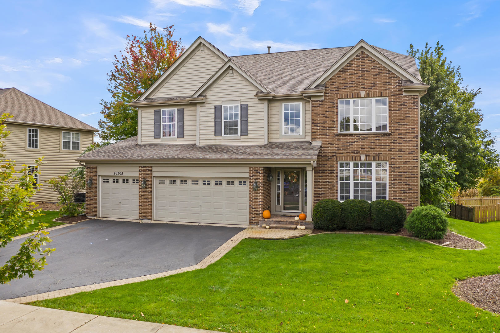 a front view of a house with a garden and plants