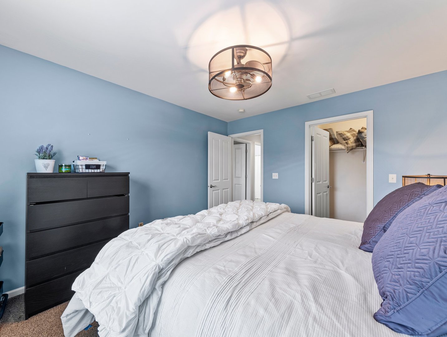 26305 Mapleview Drive Plainfield, IL 60585 - Photo 29 of 40 a bedroom with a bed and chandelier