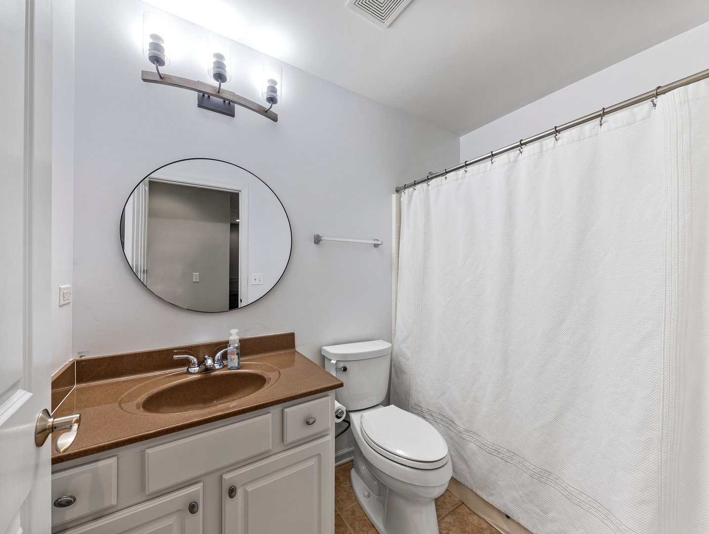 26305 Mapleview Drive Plainfield, IL 60585 - Photo 30 of 40 a bathroom with a sink a toilet and a mirror