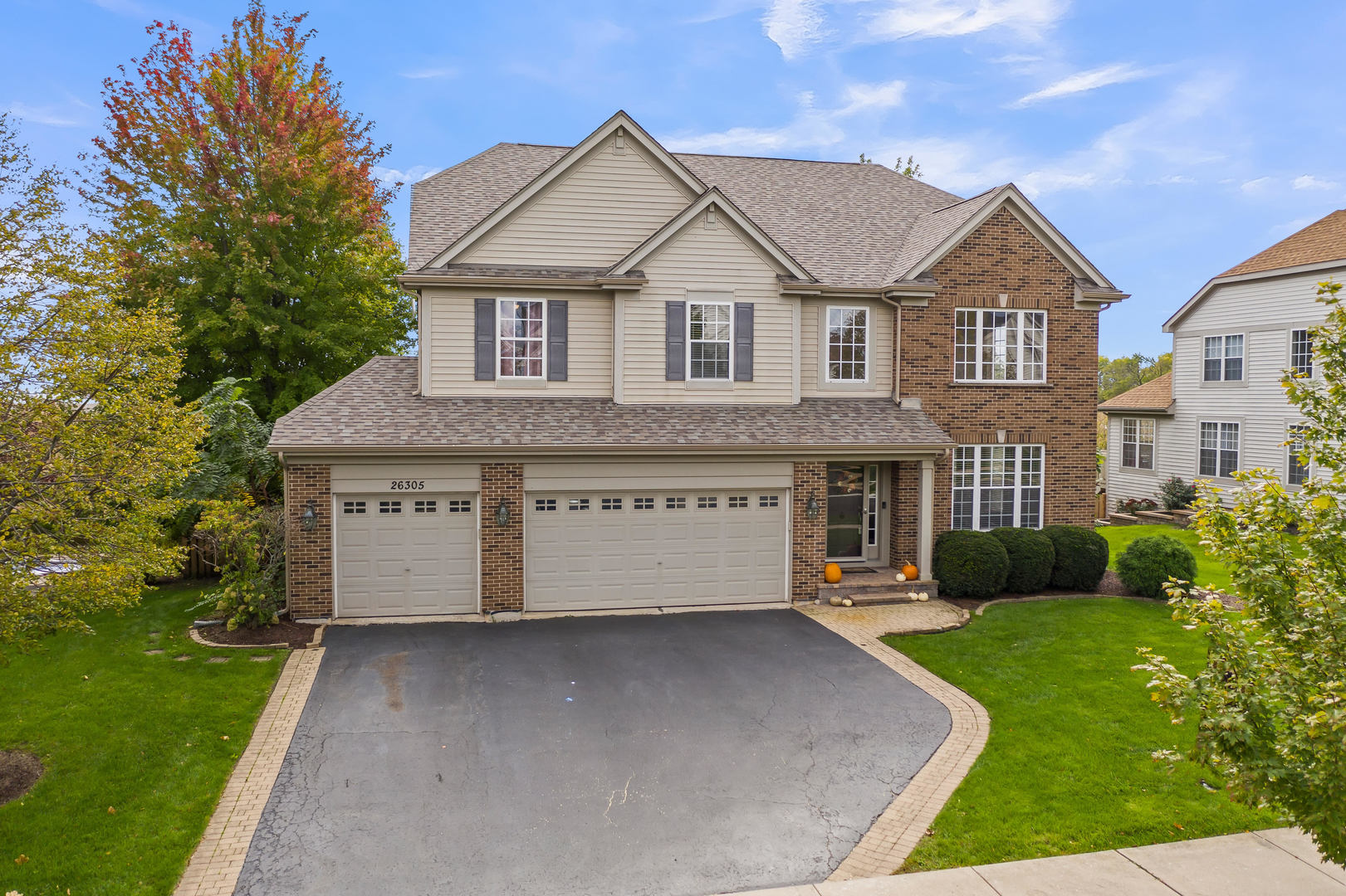 26305 Mapleview Drive Plainfield, IL 60585 - Photo 3 of 40 a front view of a house with a yard and garage