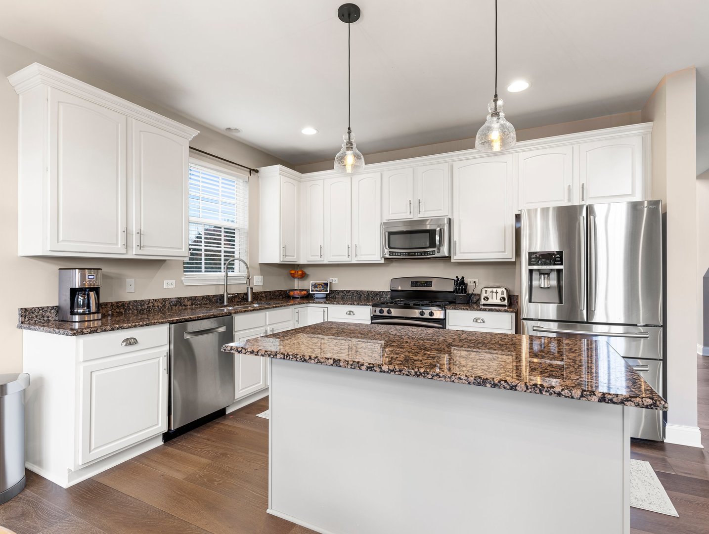 26305 Mapleview Drive Plainfield, IL 60585 - Photo 10 of 40 a kitchen with stainless steel appliances granite countertop a refrigerator a stove a sink and a microwave