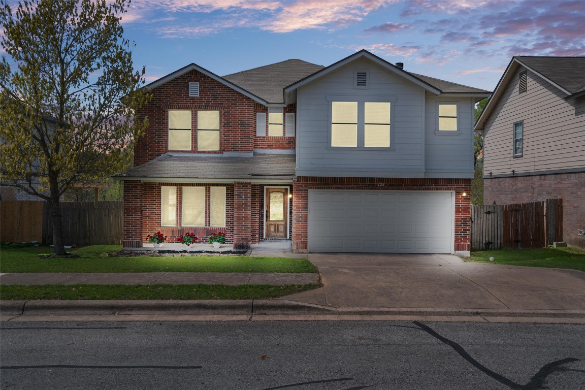 126 Vicksburg Loop Elgin, TX 78621 - Photo 1 of 1 a front view of a house with a garden and trees