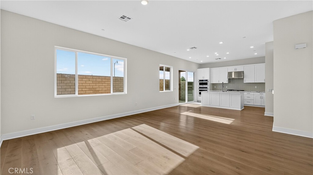 224 Lily Loop Irvine, CA 92618 - Photo 13 of 39 a view of kitchen with wooden floor and windows