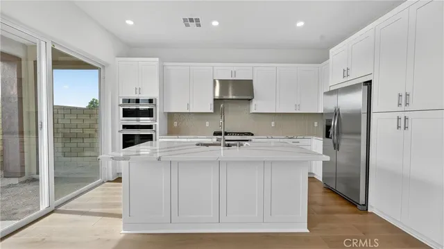 a kitchen with a refrigerator and a sink
