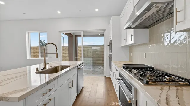 a kitchen that has a sink and a stove