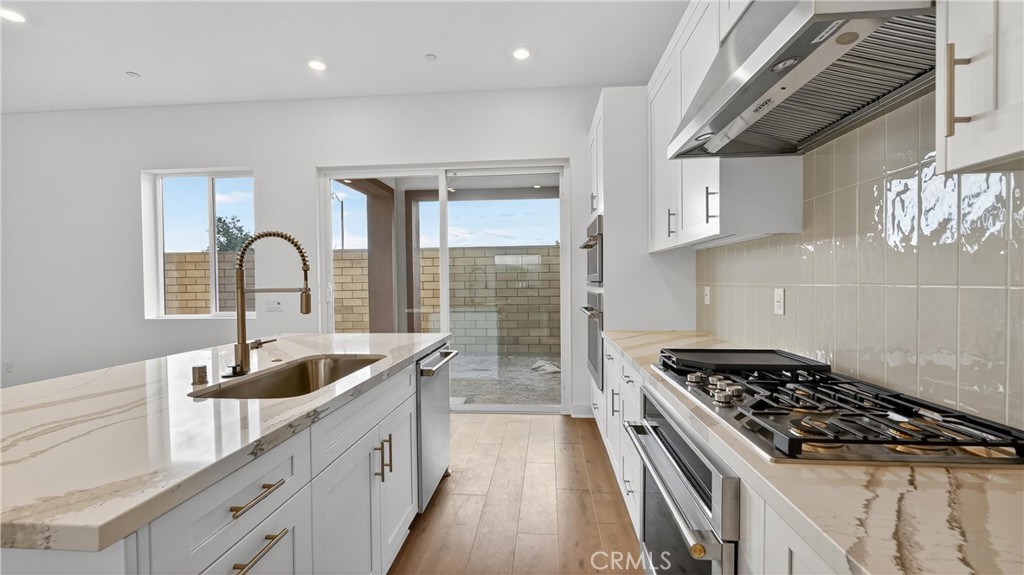 224 Lily Loop Irvine, CA 92618 - Photo 18 of 39 a kitchen that has a sink and a stove