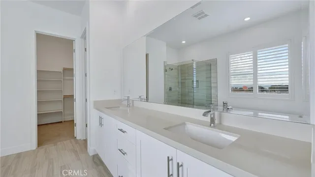 a bathroom with a double vanity sink and mirror