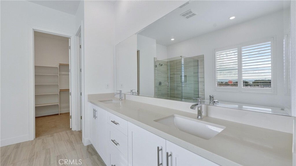 224 Lily Loop Irvine, CA 92618 - Photo 24 of 39 a bathroom with a double vanity sink and mirror
