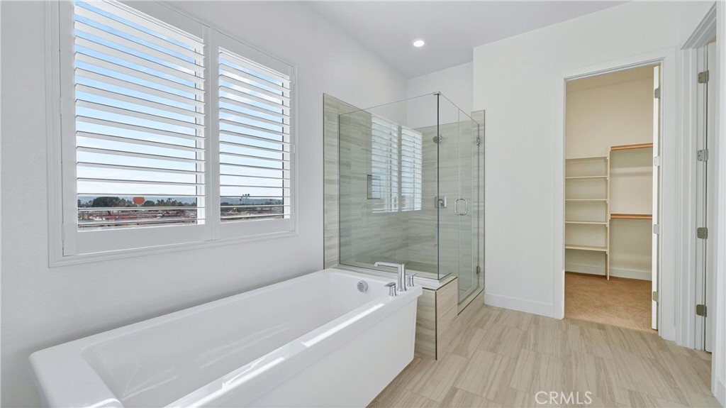 224 Lily Loop Irvine, CA 92618 - Photo 25 of 39 a bathroom with a bathtub a toilet and a shower