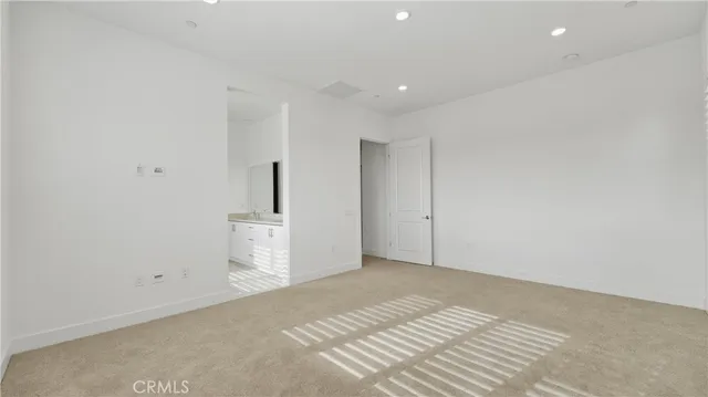 a view of a room with a sink and cabinets